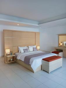 a large bedroom with a large bed and two lamps at Glisten Up Villa Beach Side Sanur! in Sanur
