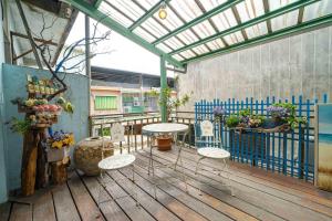 a patio with two tables and chairs on a deck at Mushroom Garden in Dongshan