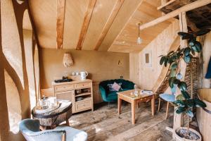 a living room with a couch and a table at Ecolodge La Belle Verte in Saint-Mʼhervé