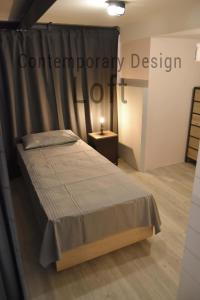 Contemporary Design Loft & Apartment Padova في بادوفا: غرفة نوم بسرير وستارة وطاولة