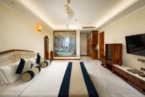 a hotel room with a bed and a television at Araliya Beach Resort & Spa Unawatuna- Where you meet the sea all year in Unawatuna