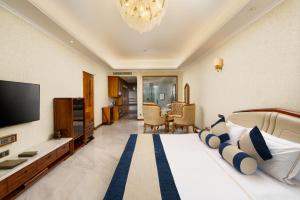 a hotel room with a bed and a television at Araliya Beach Resort & Spa Unawatuna- Where you meet the sea all year in Unawatuna