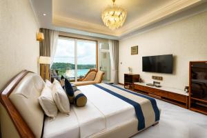 a bedroom with a large bed with a large window at Araliya Beach Resort & Spa Unawatuna- Where you meet the sea all year in Unawatuna