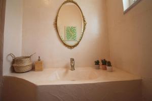 a bathroom sink with a mirror on the wall at Jasmine Sol Retreat in Delvinë +26 photos