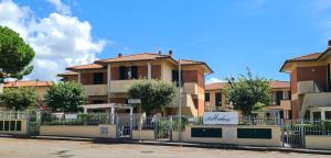 a building with a fence in front of it at Villaggio Mietta in Castiglioncello
