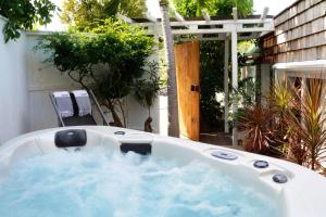 a jacuzzi tub in a yard next to at Exceptional villa with pool and spa, Saint-Barthélemy. in Saint Barthelemy
