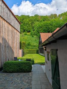 a view of a house and a yard with a building at Ferienhaus Fachwerk 99 in Stolberg