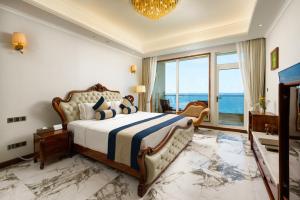 a bedroom with a bed and a large window at Araliya Beach Resort & Spa Unawatuna- Where you meet the sea all year in Unawatuna