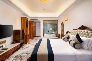 a bedroom with a large bed and a television at Araliya Beach Resort & Spa Unawatuna- Where you meet the sea all year in Unawatuna