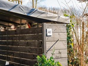 a wooden shed with a number on it at Cosy holiday home in Appelscha with garden in Appelscha