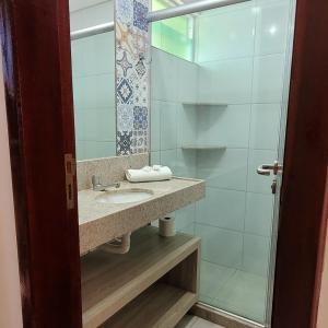 a bathroom with a sink and a shower at Pousada Solar Dos Carneiros in Praia dos Carneiros