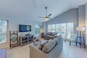 a living room with a couch and a flat screen tv at Long Island Village Unit 111 in Port Isabel