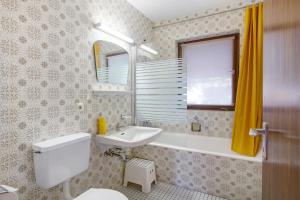 a bathroom with a white toilet and a sink at Haus vor Anker in Feldberg