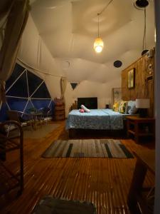 a bedroom with a bed in a tent at Glamping Dome Dauin Beach Resort in Dauin