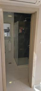 a glass door of a shower in a bathroom at Relax for you Apartmanház in Cserkeszőlő