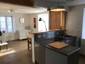 a kitchen with a sink and a counter top at Domaine La Bonne Dame - Merle, au coeur des Vosges in Plainfaing +25 photos