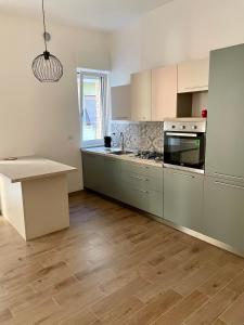 a kitchen with stainless steel appliances and wooden floors at Casa Viola in San Benedetto del Tronto