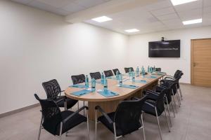 une salle de conférence avec une grande table et des chaises dans l'établissement Occidental Torremolinos Playa, à Torremolinos