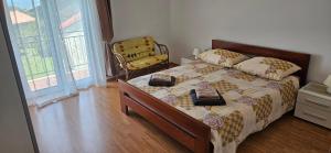 a bedroom with a bed and a chair at Sea view apartment Renzzo in Strunjan