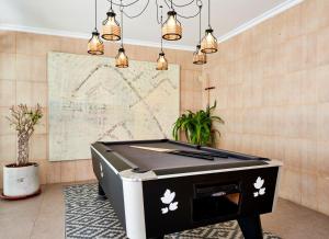a pool table in a room with lights at Flacalco Hotel & Apartments in Cala Ratjada +111 photos