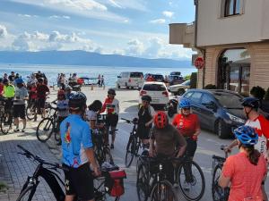 a group of people riding bikes down a street at Penelopa Apartments in Ohrid +26 photos