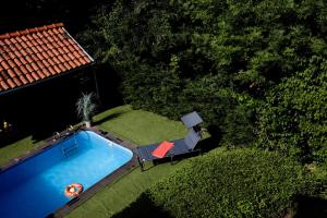 an overhead view of a swimming pool next to a house at Wildflower Orfű in Orfű
