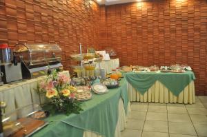 a room with two tables with plates of food at Albergo Fiorenza in Salerno