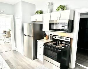 a kitchen with a black stove and a refrigerator at Tranquility Cottage in Anderson