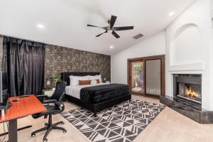 a bedroom with a bed and a desk and a fireplace at Luxury Scottsdale Retreat Heated Pool and Mini Golf in Phoenix