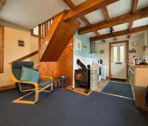 a living room with a chair and a stove at Lamlash- Self catering accommodation with seaviews in Lamlash