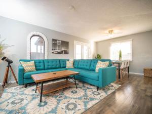 a living room with a blue couch and a table at Modern, Tempe Oasis! Private Pool, Sleeps 12 in Tempe