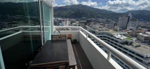 a balcony with a bench on top of a building at Patong tower 2bedroom 2 bathrooms, corner view in Patong Beach