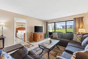 a living room with a couch and a table at Edgewater Golf Villa 605 in Panama City Beach