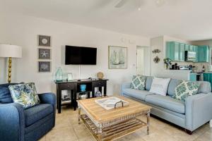 a living room with two couches and a coffee table at South Beach Cabana Up (Private Front Deck, Pool, Steps from the Beach) in Fernandina Beach +14 photos