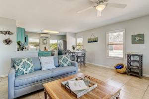 a living room with a couch and a table at South Beach Cabana Up (Private Front Deck, Pool, Steps from the Beach) in Fernandina Beach