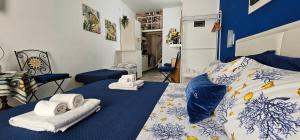 Posteľ alebo postele v izbe v ubytovaní La Piccola Perla di Ortigia