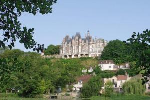 a large castle on top of a hill with houses at Studio 28 À l'orée de l'eau in Cloyes-sur-le-Loir