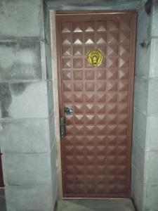 a brown door with a gold knocker on it at Armenia Home in Pʼarakʼar