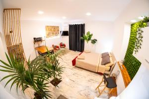 a living room with a couch and some plants at L'ombelico del Monte - appartamenti in centro storico in Piazza Armerina