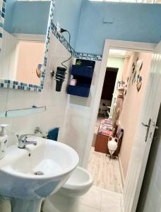 a bathroom with a sink and a toilet at La Graziosa casetta in Cagliari