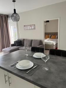 a living room with a table with plates and wine glasses at Cozy Apartment by the sea in Limassol