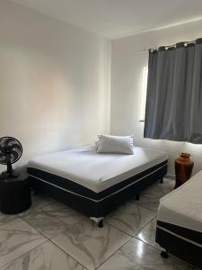 Posteľ alebo postele v izbe v ubytovaní Apartamento para temporada HospedagemOuroPreto202