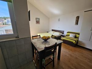 a room with a table and a bed and a couch at Studio apartment in Duce with sea view, balcony, air conditioning, WiFi 5067-6 in Duće