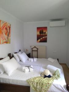 a bedroom with two beds with hats and towels on them at Nostalgia Apartments B Plus in Sami 50 meters from the sea in Sami