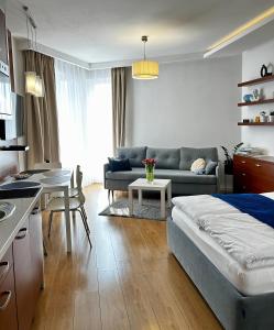 a living room with a couch and a table at Apartament A&K Marina Kąty Rybackie in Kąty Rybackie
