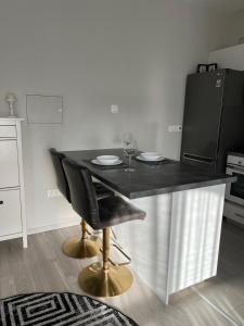 a kitchen with a table with two glasses of wine at Cozy Apartment by the sea in Limassol