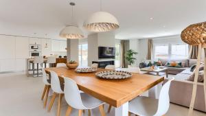 a kitchen and living room with a wooden table and chairs at Apartment Alice in Port de Pollensa