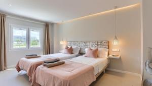 a bedroom with two beds and a window at Apartment Alice in Port de Pollensa