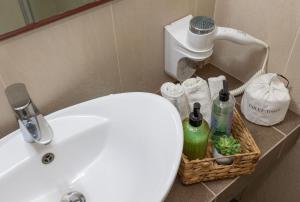 a bathroom with a white sink and a toilet at Oinoni's Home - XANTHIPI apartment in Souvala