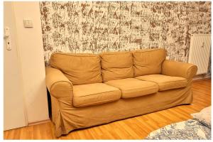 a brown couch sitting in a living room at Cutie apartment in Bratislava
